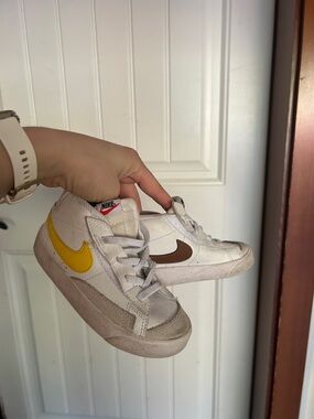 Nike White Low-Top Sneakers with Yellow and Brown Swooshes